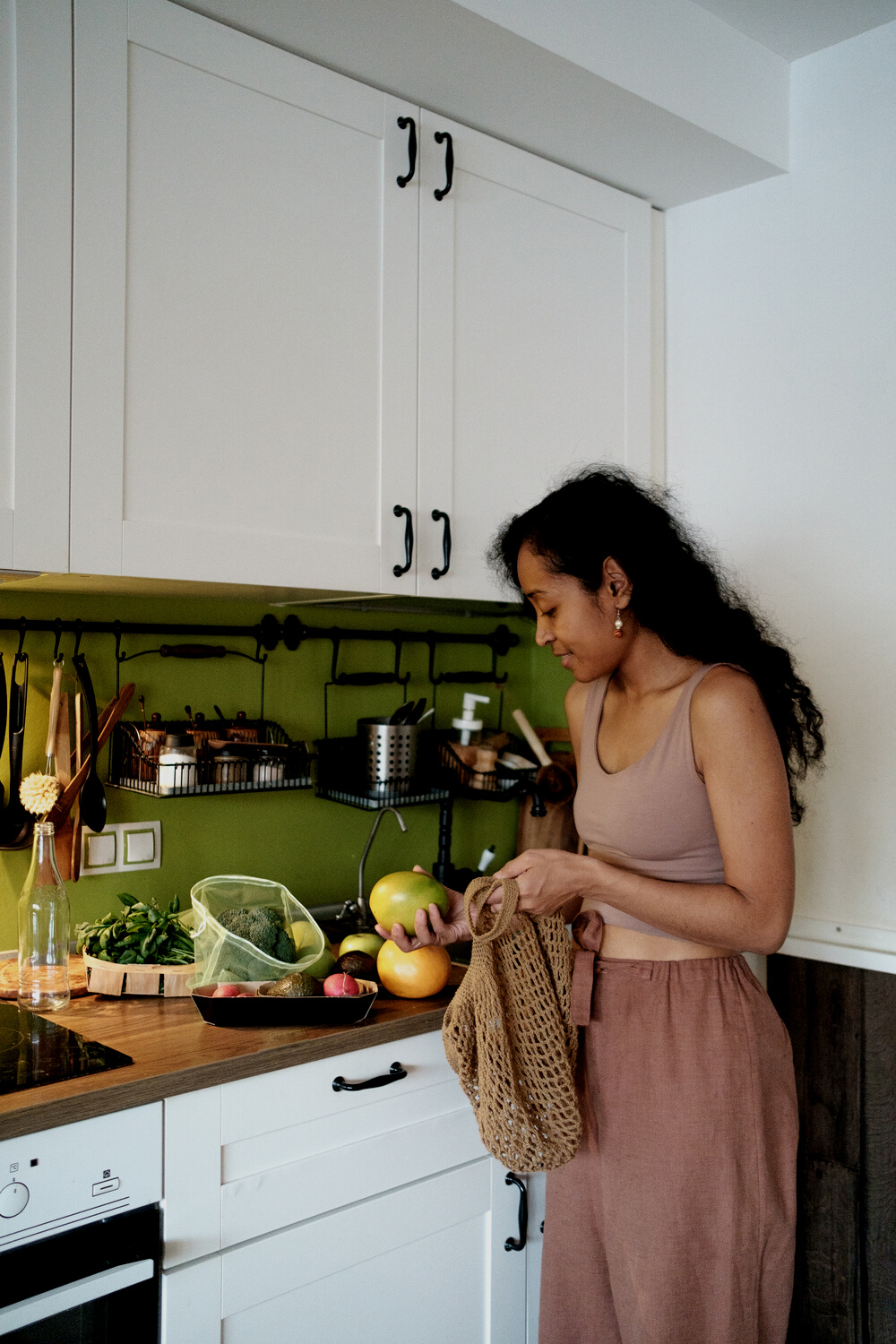 Woman Getting Produce from Cotton Bag