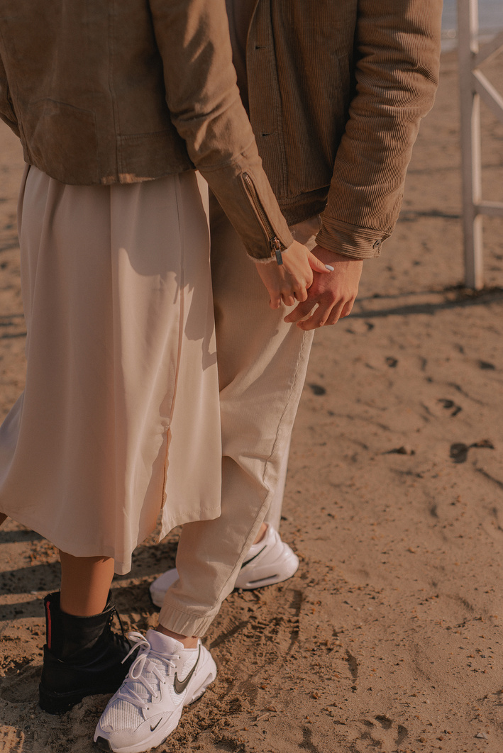 Photograph of a Couple Standing on the Sand